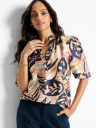 Terracotta top with abstract print in beige,  dusty rose, and navy.  Short sleeves, V-neck.