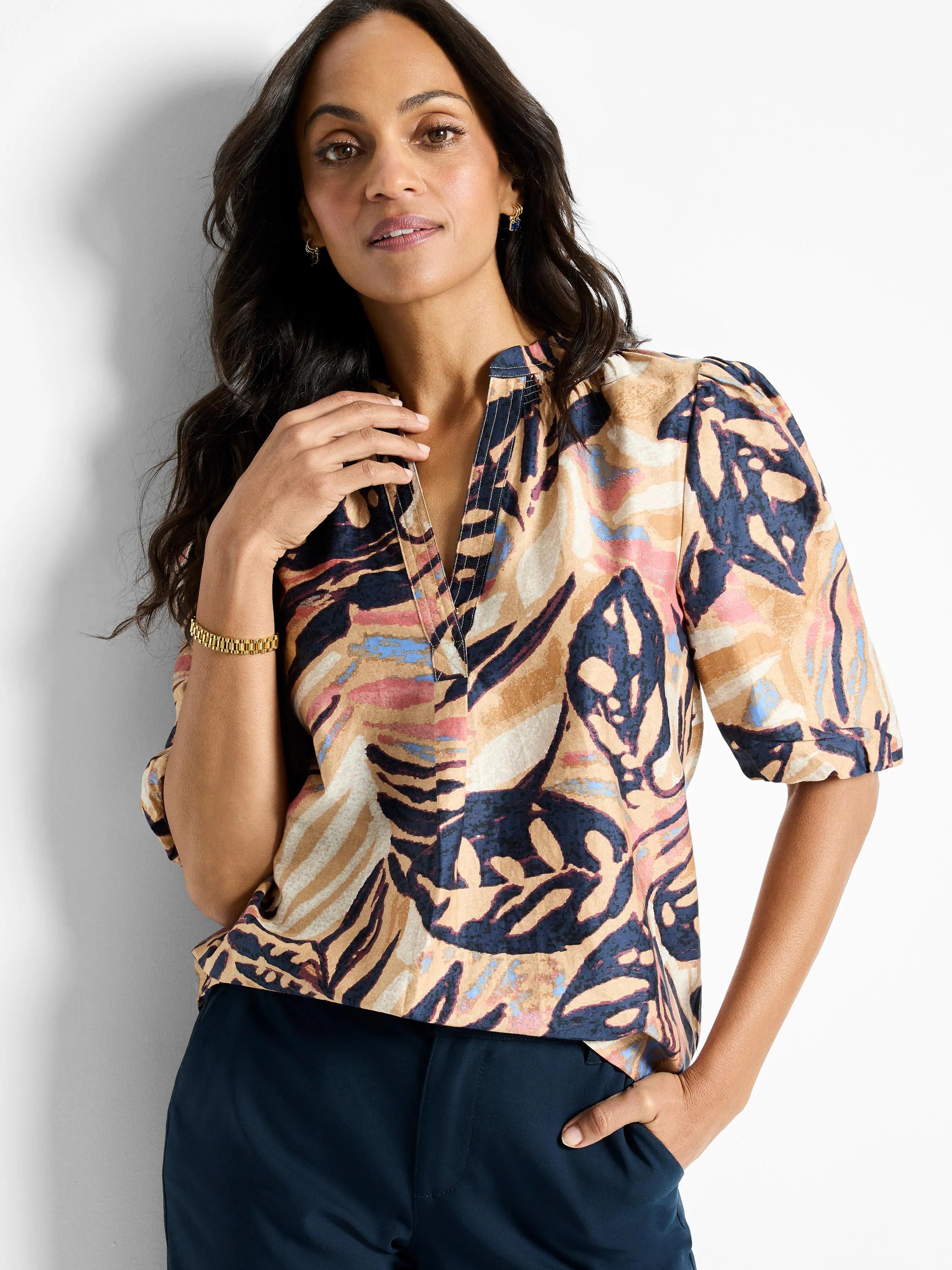 Terracotta top with abstract print in beige,  dusty rose, and navy.  Short sleeves, V-neck.