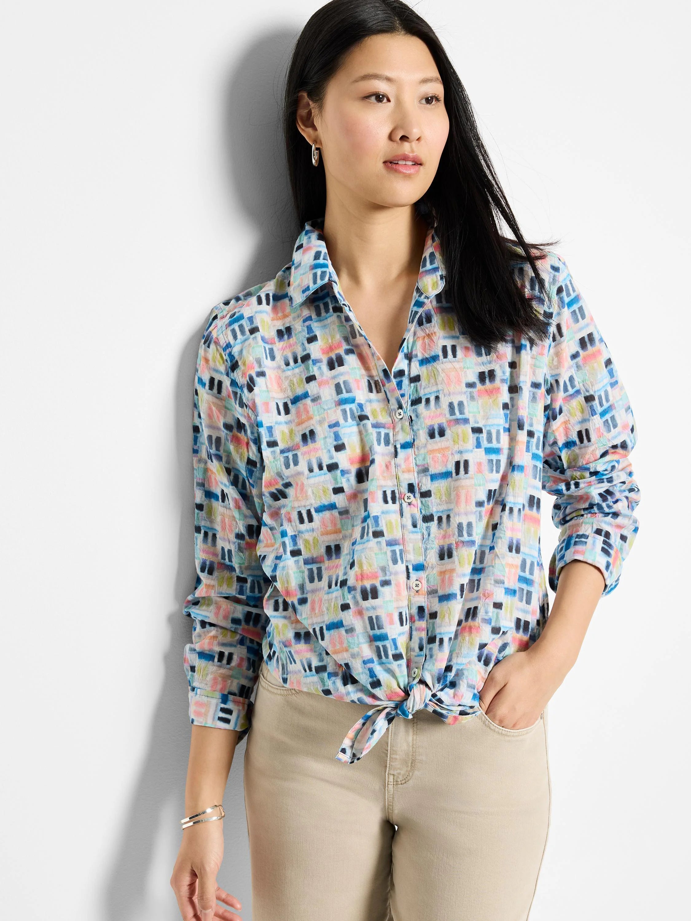 Cotton shirt with long sleeves, button closure, and an abstract print in blues, pinks, and greens on a white background. ...
