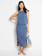 Blue linen midi skirt with a side slit.  Model is wearing it with a matching top and sandals.