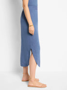 Blue linen midi skirt with a side slit.  A-line shape.