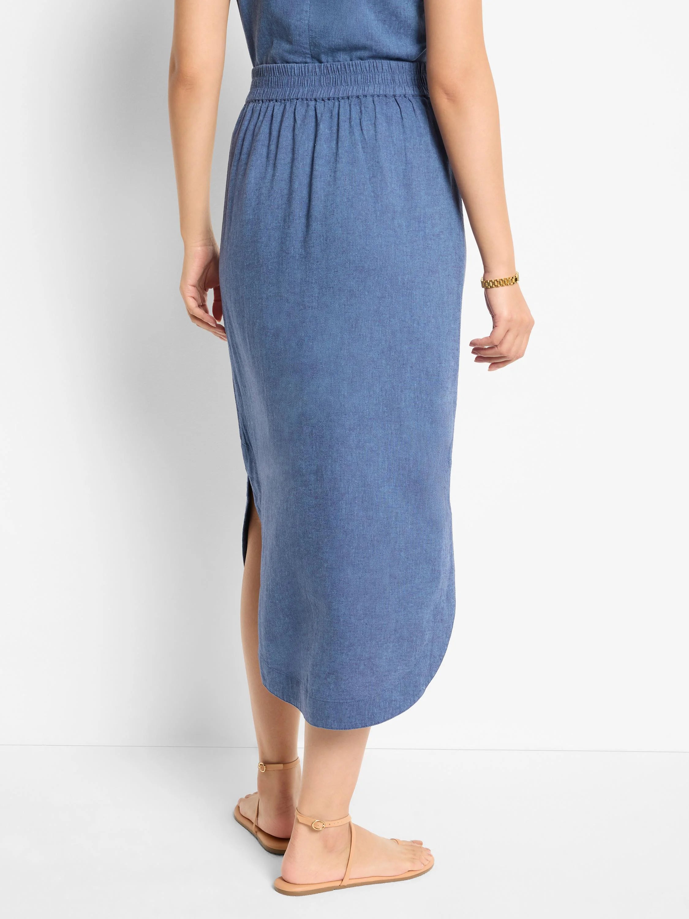 Blue linen midi skirt with elastic waistband and side slit.  A-line shape.