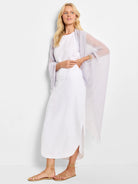 White linen midi skirt with a side slit; model wears a lavender shawl.