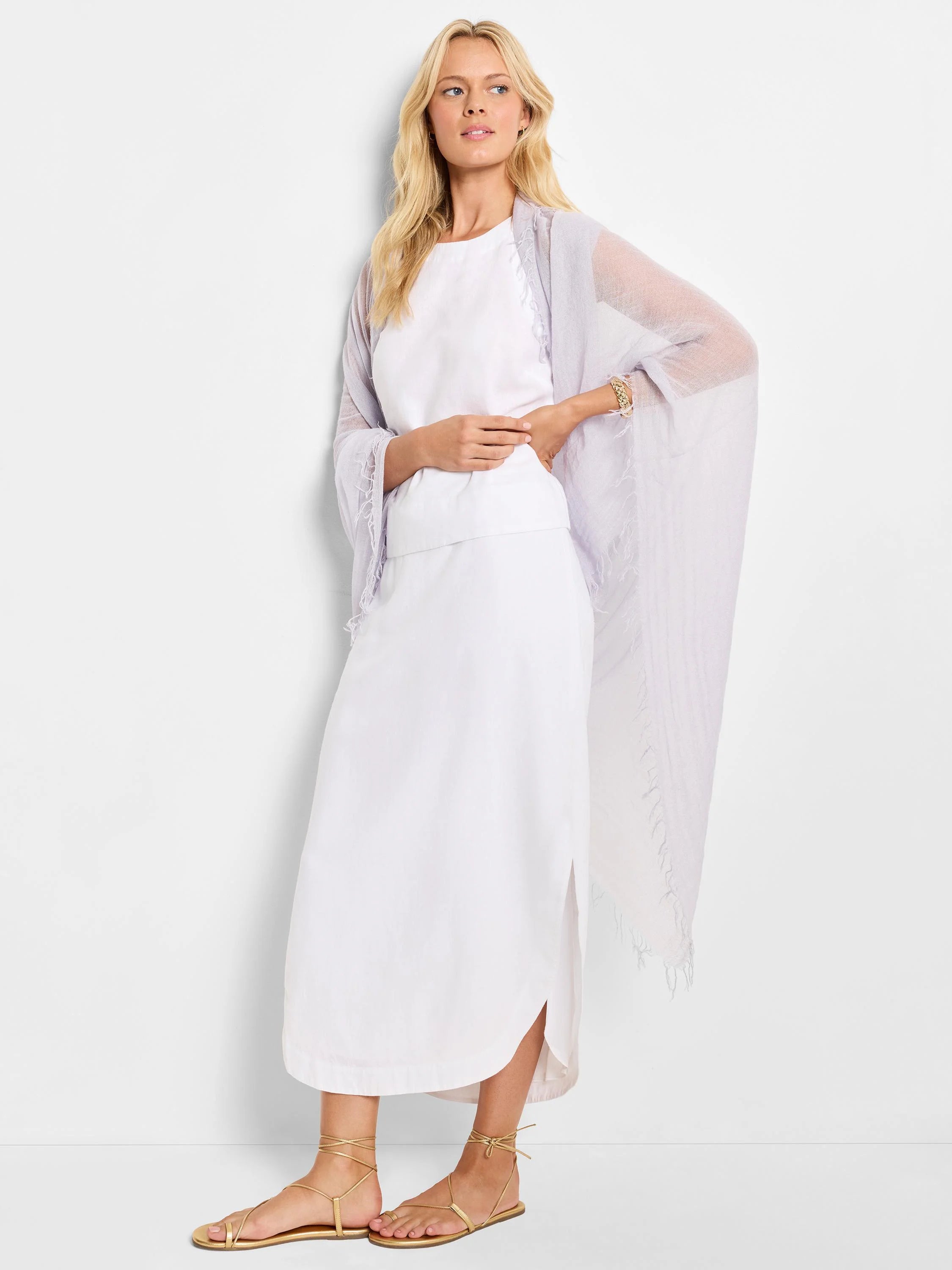 White linen midi skirt with a side slit; model wears a lavender shawl.