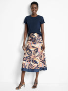 Terracotta midi skirt with a navy blue band at the hem.  Features a leaf print in terracotta, navy, blush pink, and light...