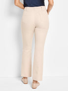 Light beige demi boot-cut pants, shown from behind, with two rear patch pockets and belt loops.