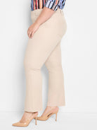 Light beige demi boot pants. Features belt loops, flat front, and subtle back pockets.