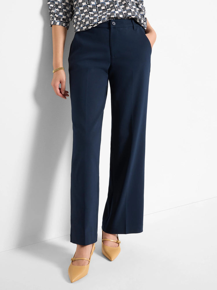Navy blue wide-leg trousers, shown on a model.  The trousers have a mid-rise waist and a straight leg.