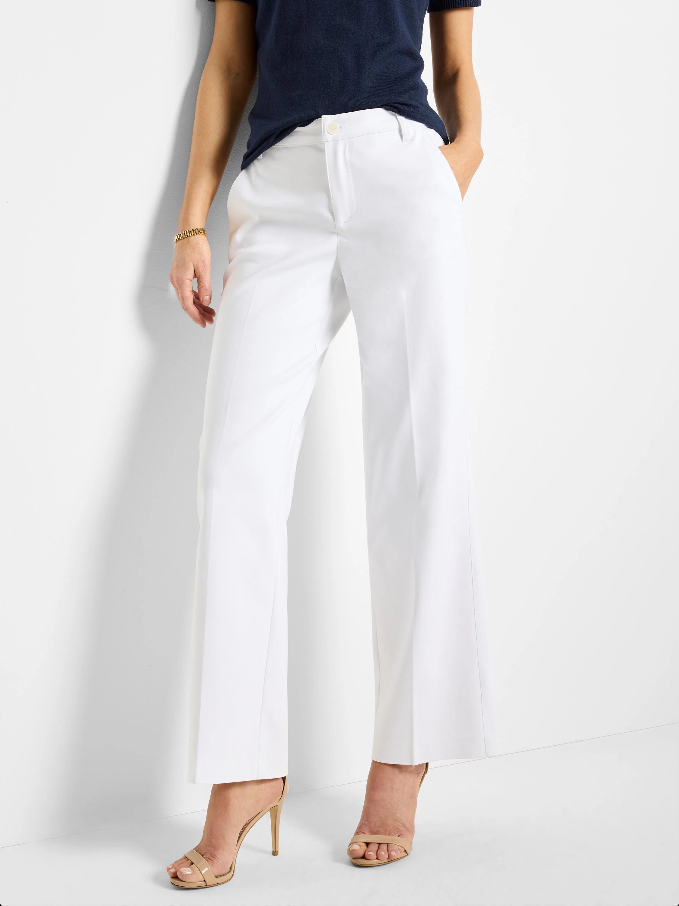 White wide-leg trousers; front view.  Model wears nude heels.