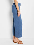 Side view of blue linen wide-leg pants with a drawstring waist.