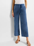 Blue linen wide-leg cropped pants with a matching rope belt and tassels.