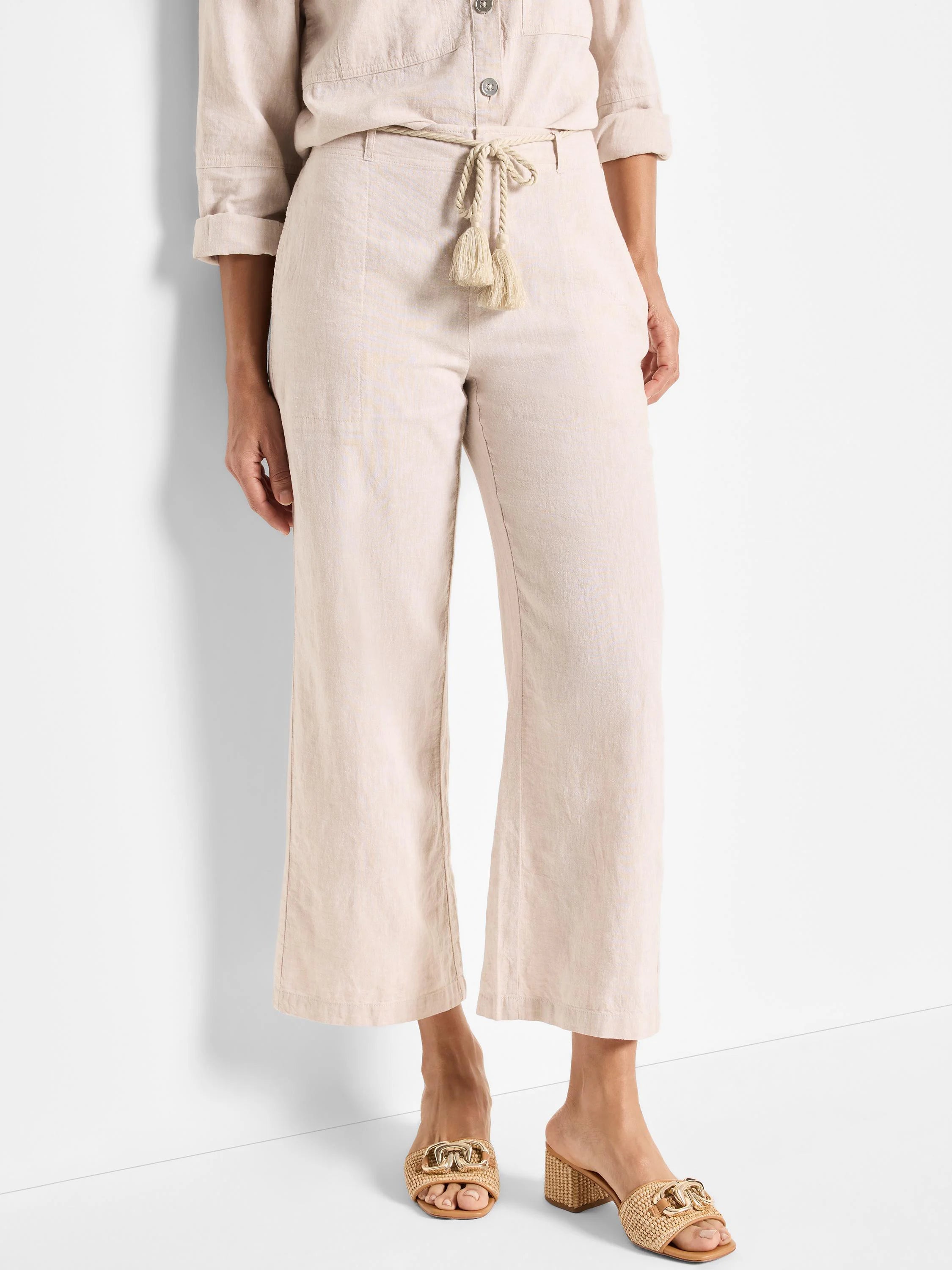 Beige linen pants with a beige rope belt and tassels.  Wide leg, cropped.