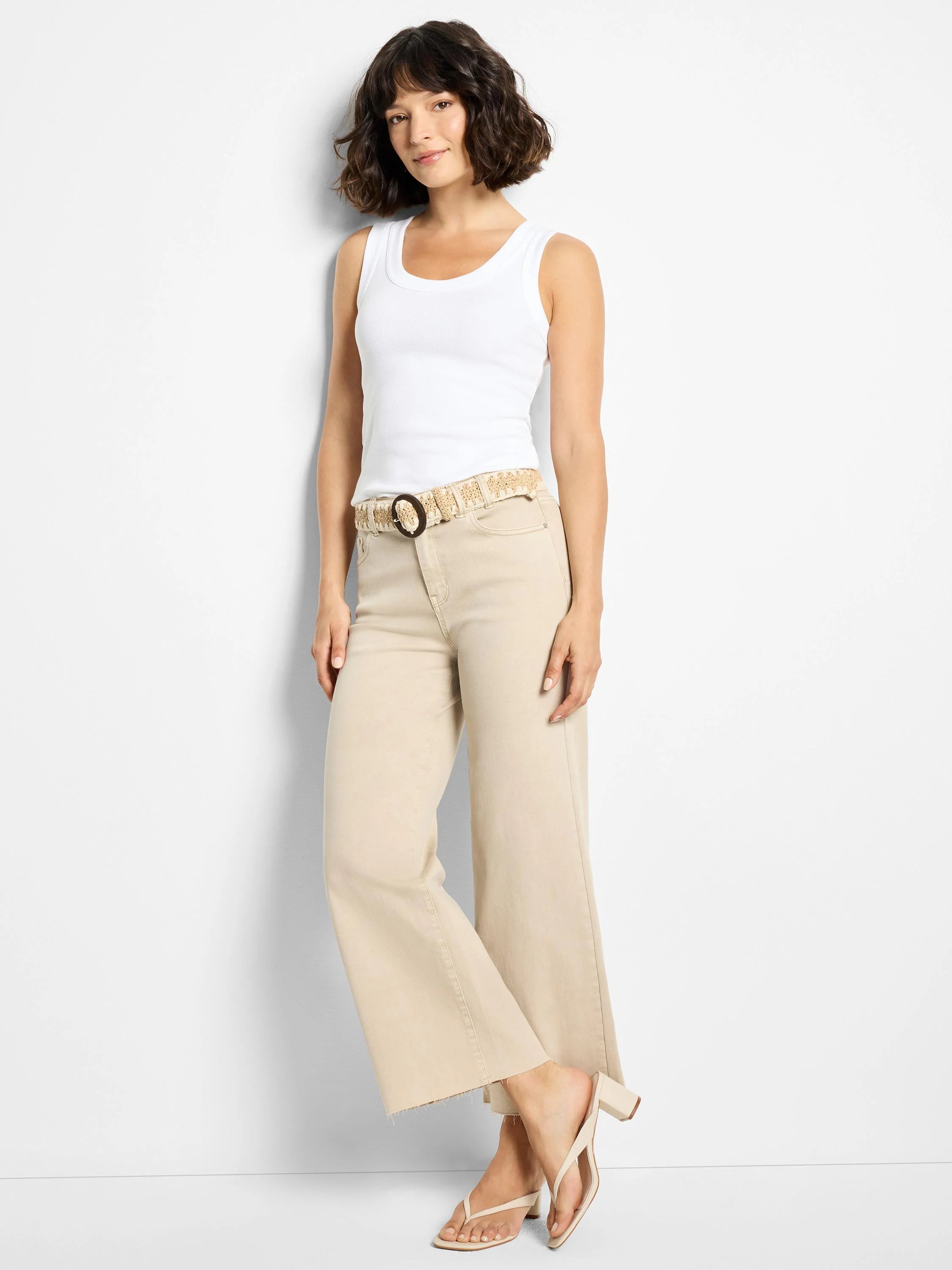 Sand-colored wide-leg jeans with a raw hem.
