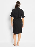 Black linen dress, short sleeves, collared neckline, belted waist.  Back view.