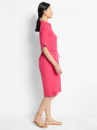 Pink linen midi dress, short sleeves, belted waist.  Side view.