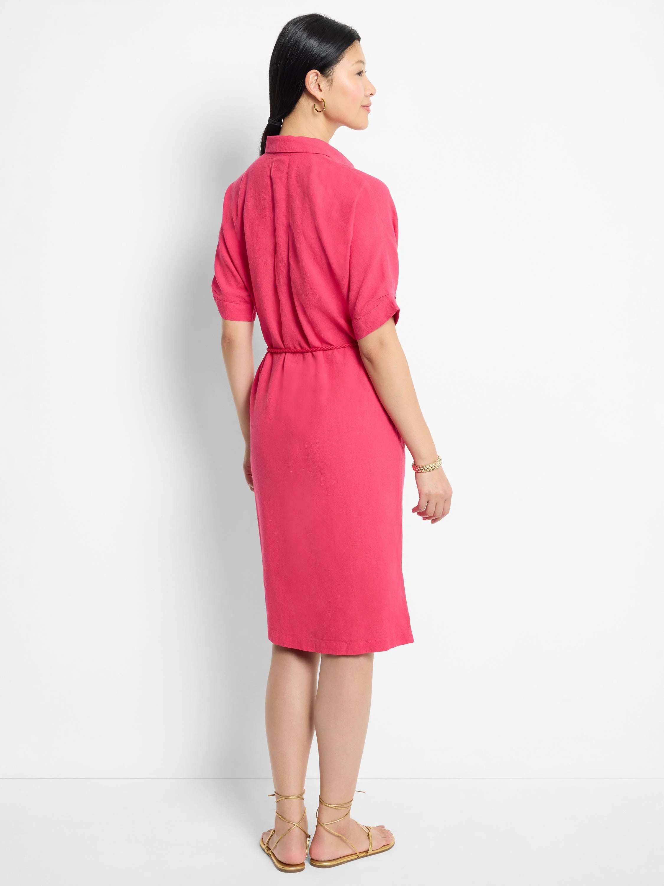 Pink midi dress, short sleeves, belted waist.  Back view.