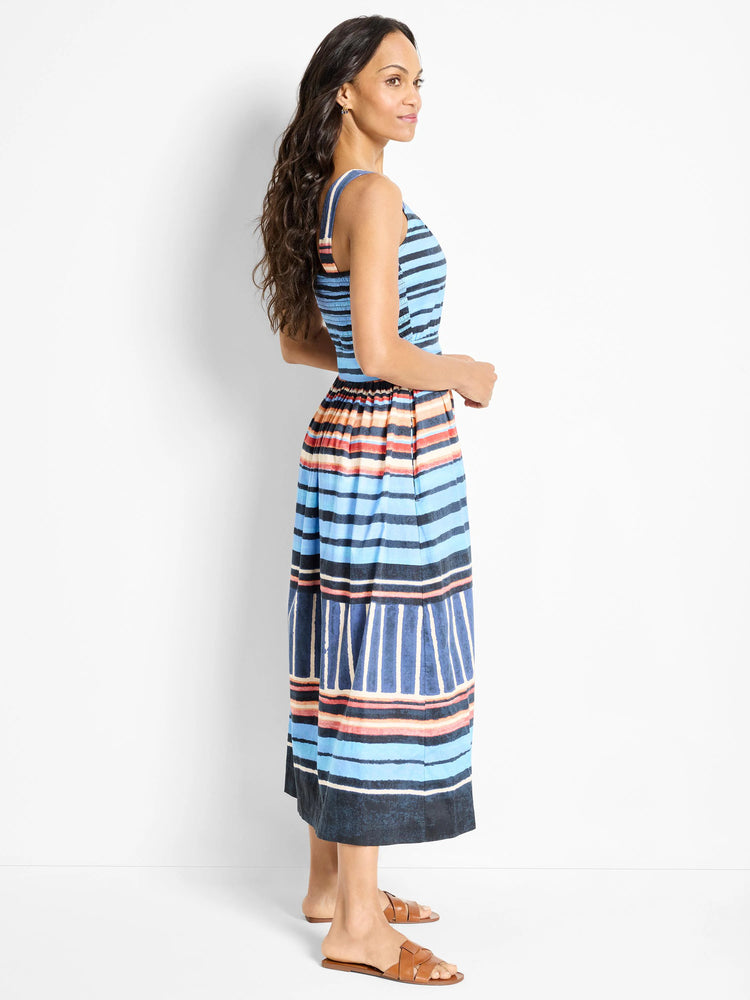 Midi-length sleeveless dress; horizontal stripes in blue, orange, and dark-blue on a lighter blue background.  The dress...