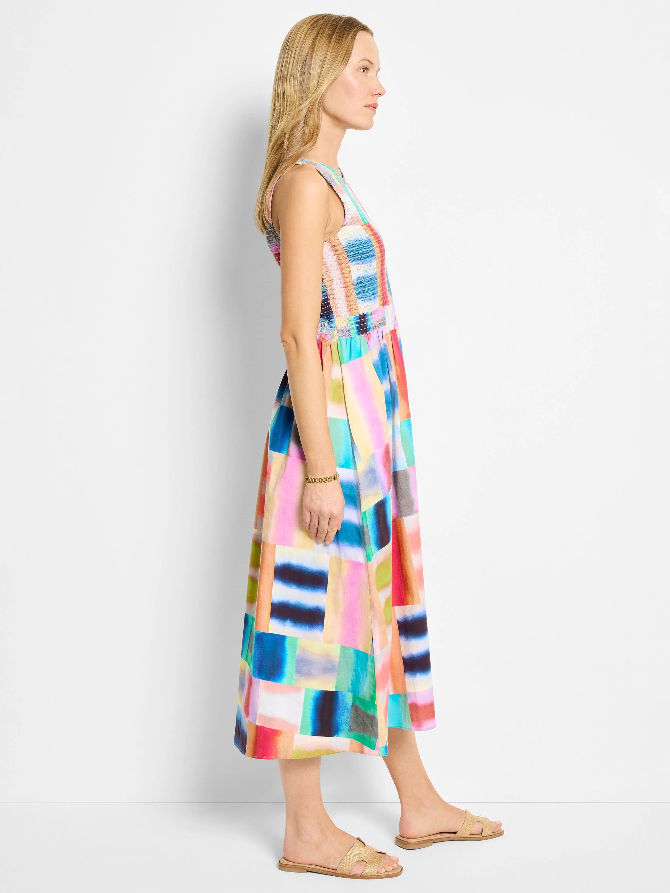 Midi-length sleeveless dress.  Abstract colorful block print in pinks, blues, greens, and oranges.  Smocked bodice.