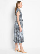 Midi dress, white background with black & blue geometric pattern, short sleeves, belted waist.