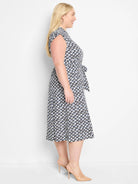 Midi dress; white background with black & navy geometric print; short sleeves; belted waist.