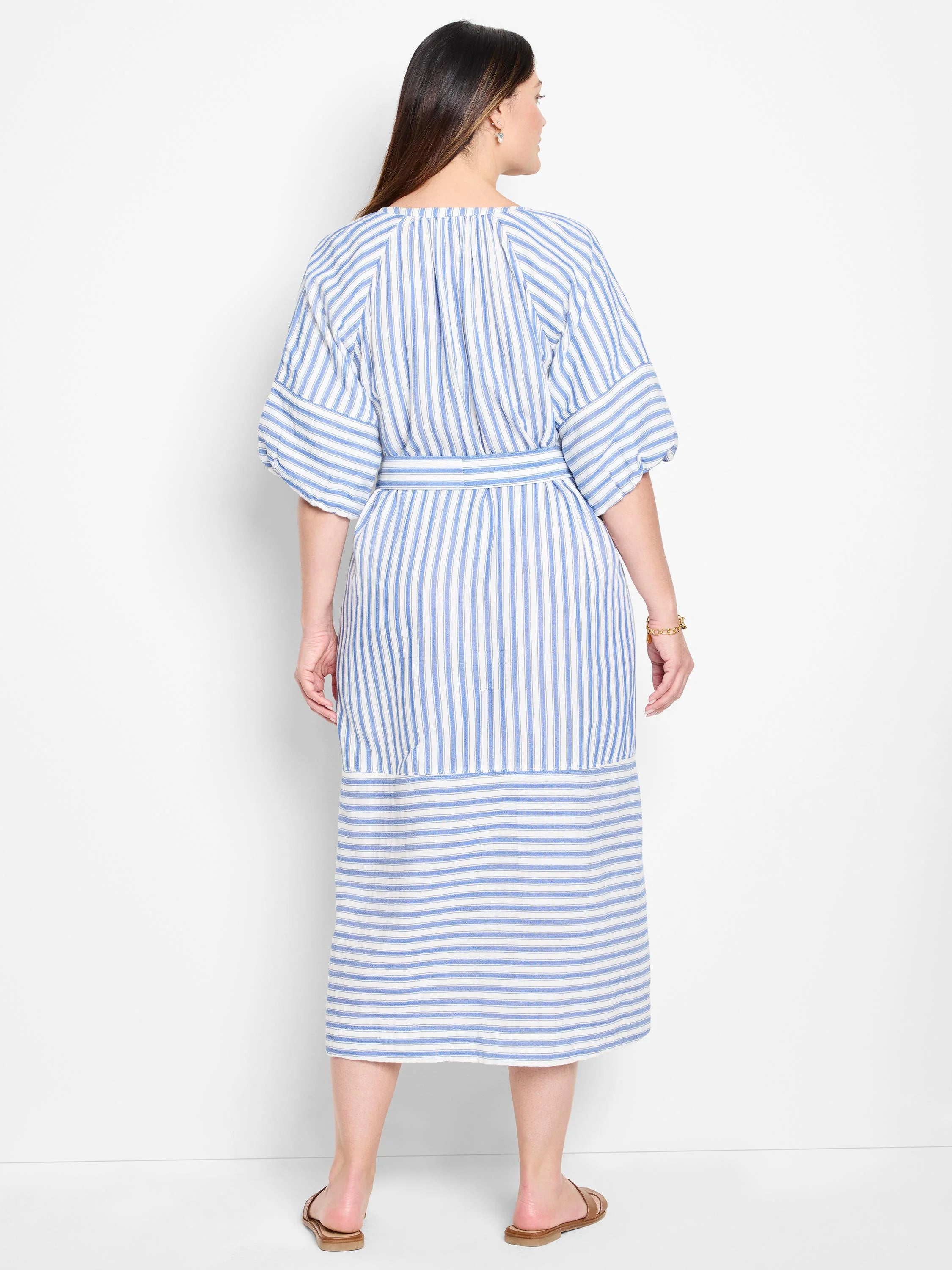 Blue and white vertical striped midi dress with a belted waist and short puff sleeves.