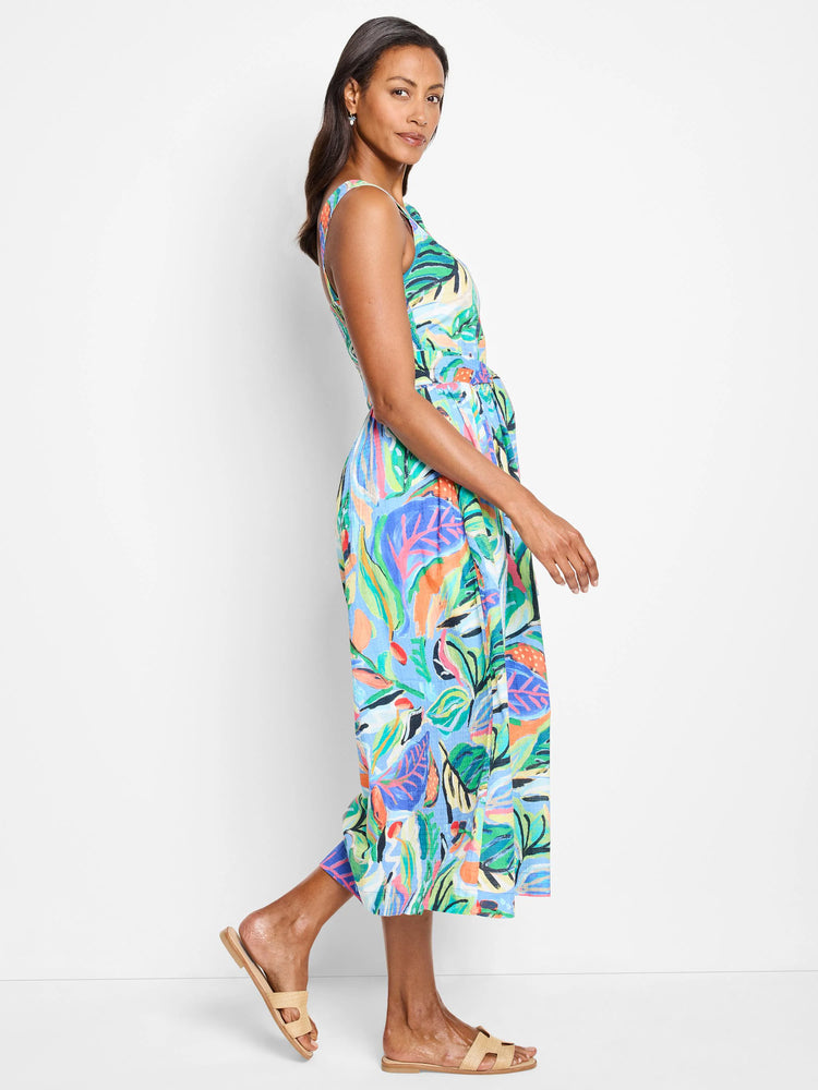 Midi sleeveless dress, light blue background, with a colorful abstract tropical print in pinks, greens, oranges, and...