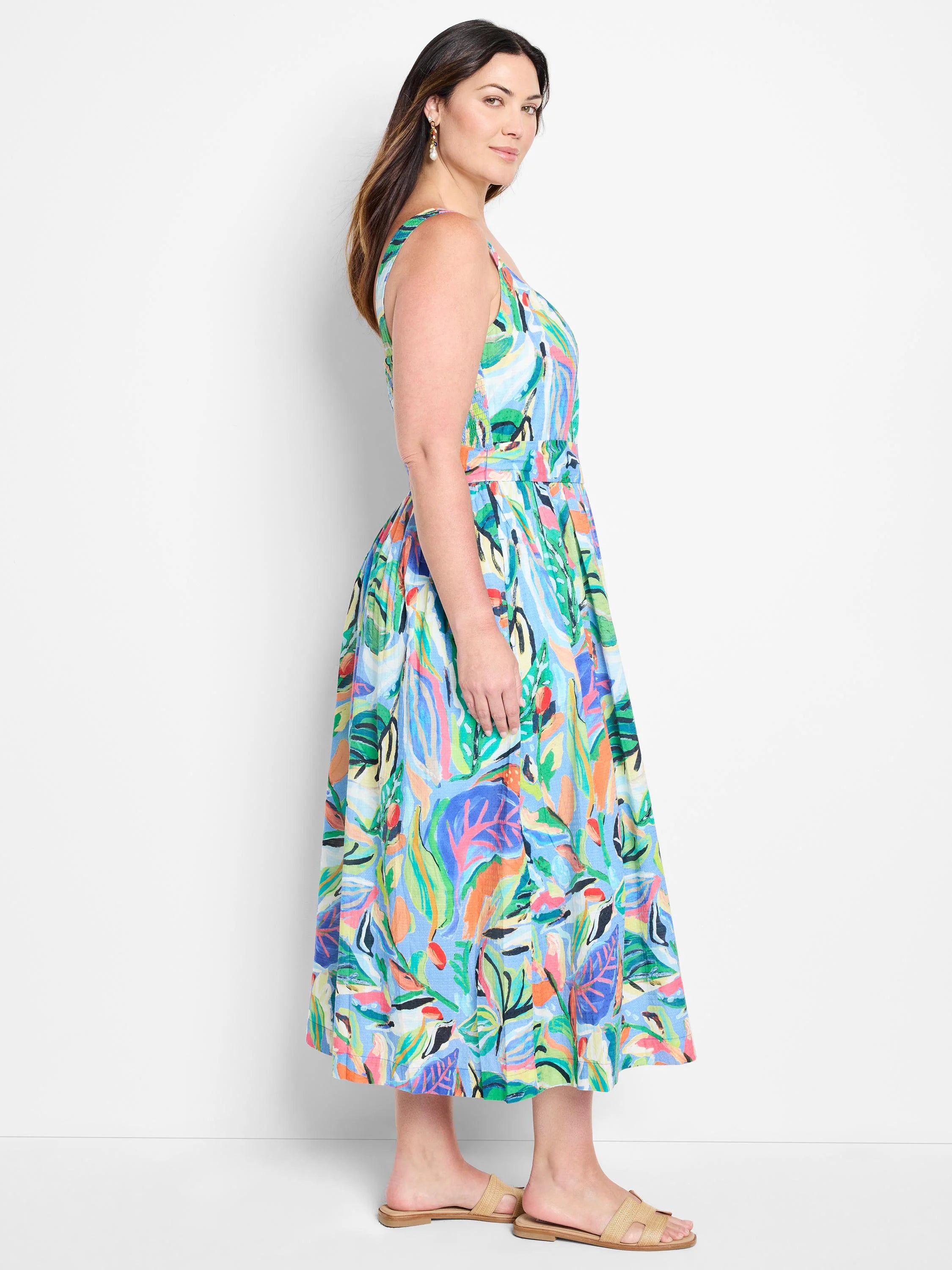 Midi sleeveless dress, light blue base with multicolored abstract leaf print.  Features a belted waist.