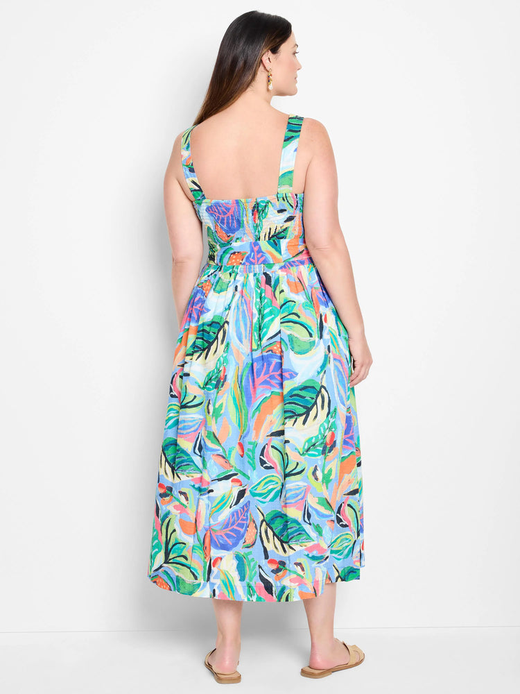 Midi dress, sleeveless,  blue background with green, orange, & purple abstract leaf print.  Square neckline, back view.