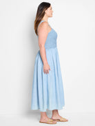 Light blue denim midi dress, smocked bodice, sleeveless, A-line skirt.
