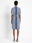 Here's alt text for the image, under 125 characters:

"Blue and white patterned midi dress with short sleeves and a...