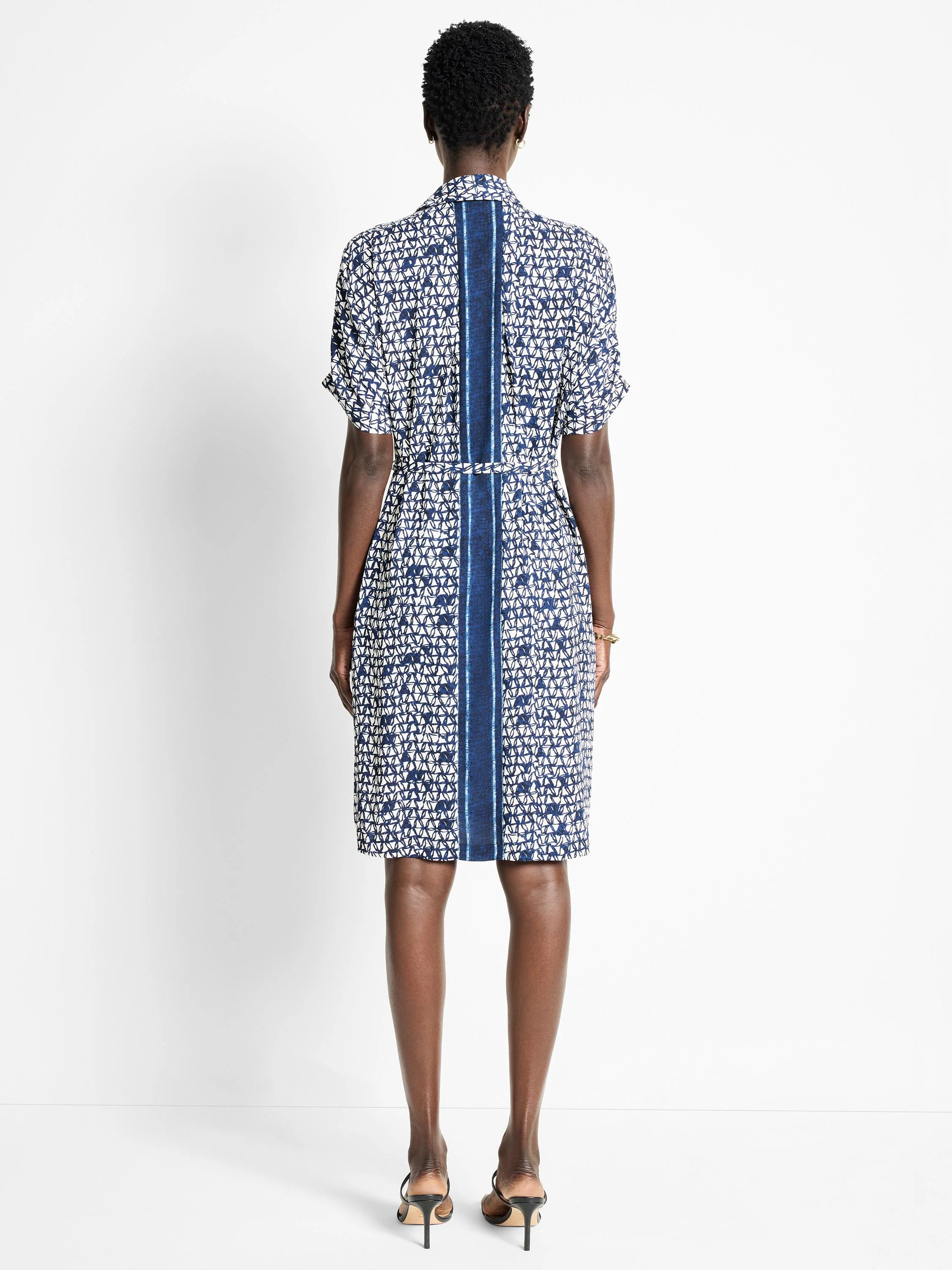Here's alt text for the image, under 125 characters:

"Blue and white patterned midi dress with short sleeves and a...