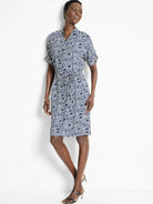 Knee-length belted shirt dress in navy blue and off-white geometric print.  Short sleeves, collared neckline.