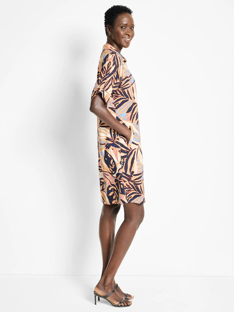 Terracotta, navy, and blush-toned leaf print knee-length shirt dress with short sleeves and pockets.