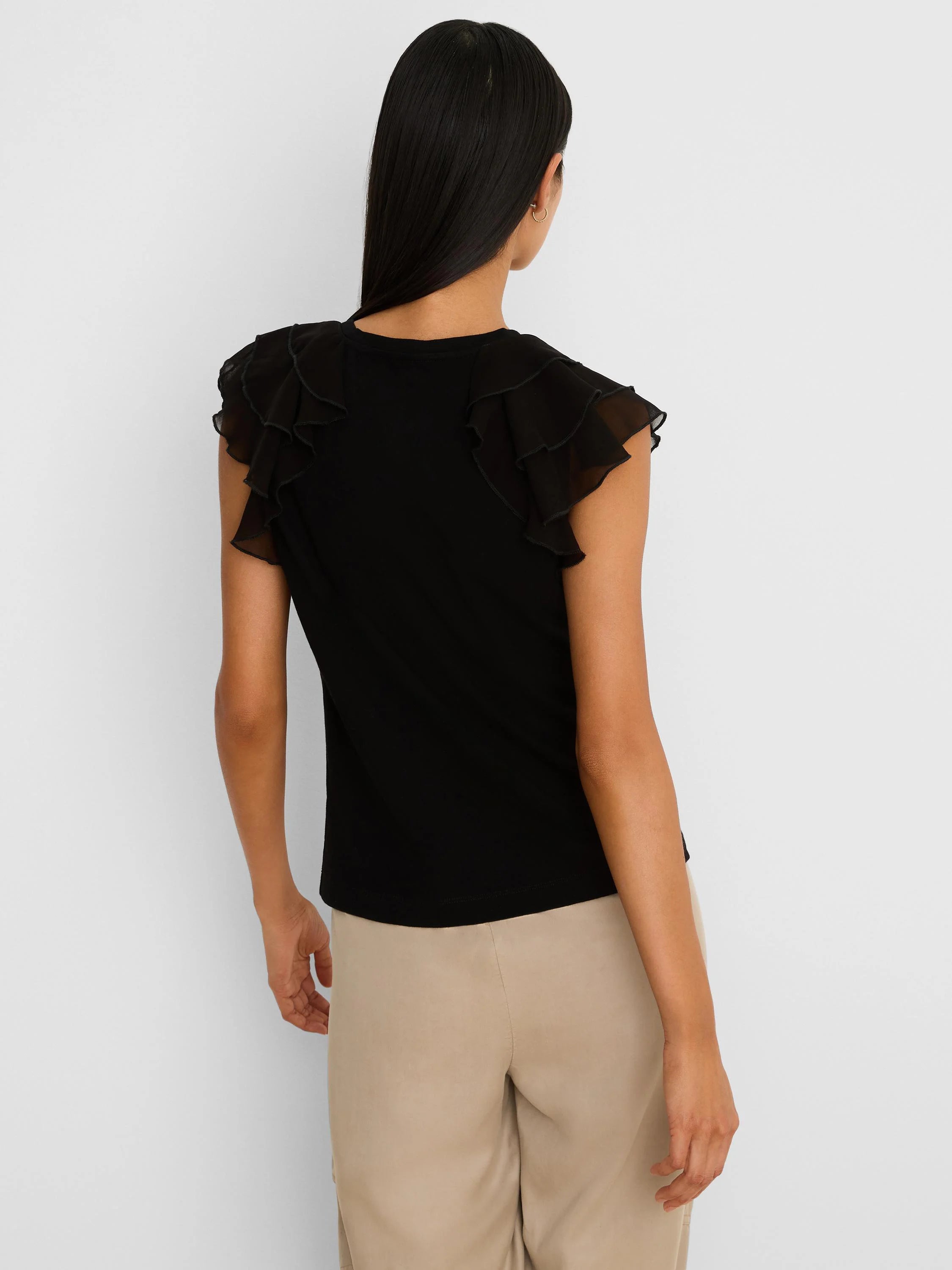 Black top with sheer, layered chiffon ruffle short sleeves, shown from the back.