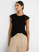Black top with chiffon ruffle cap sleeves.