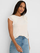 Cream top with round neck and tiered chiffon ruffle short sleeves.