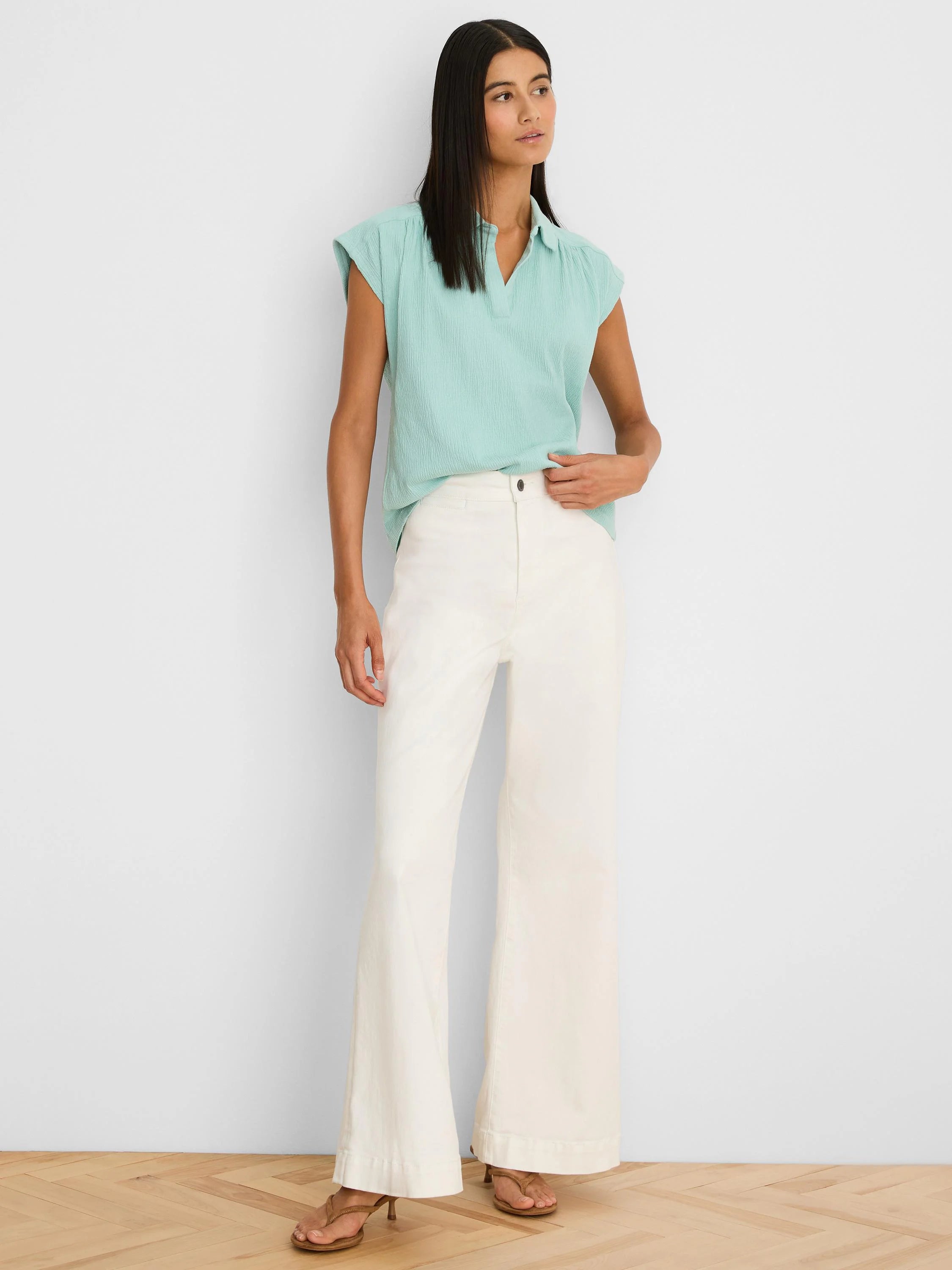 Light aqua crinkle top with cap sleeves and a collared V-neck.