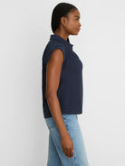 Navy blue sleeveless crinkle top with a collar.