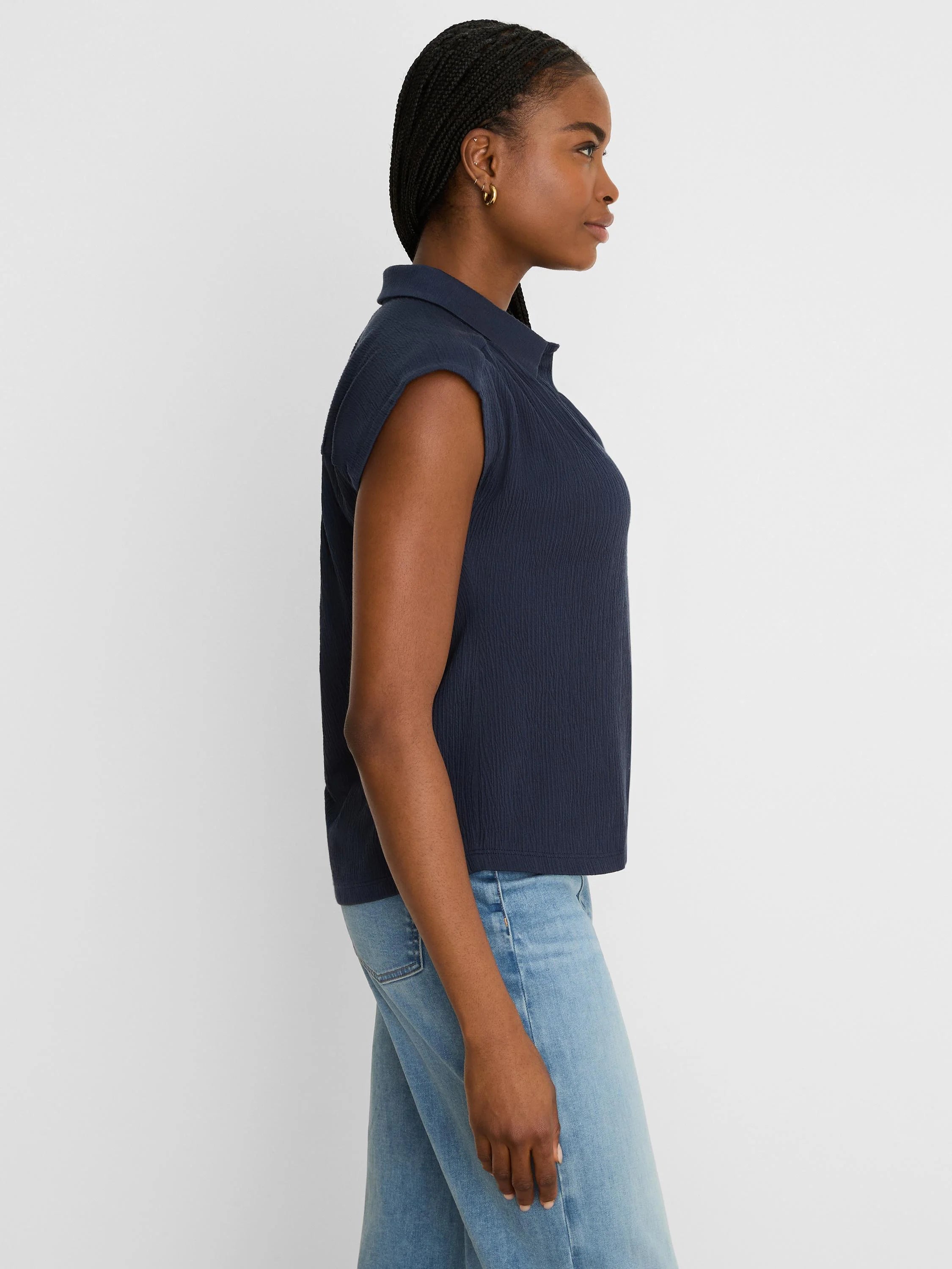 Navy blue sleeveless crinkle top with a collar.