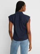 Navy crinkle top, seen from behind, features a collar, cap sleeves, and a gathered back yoke.