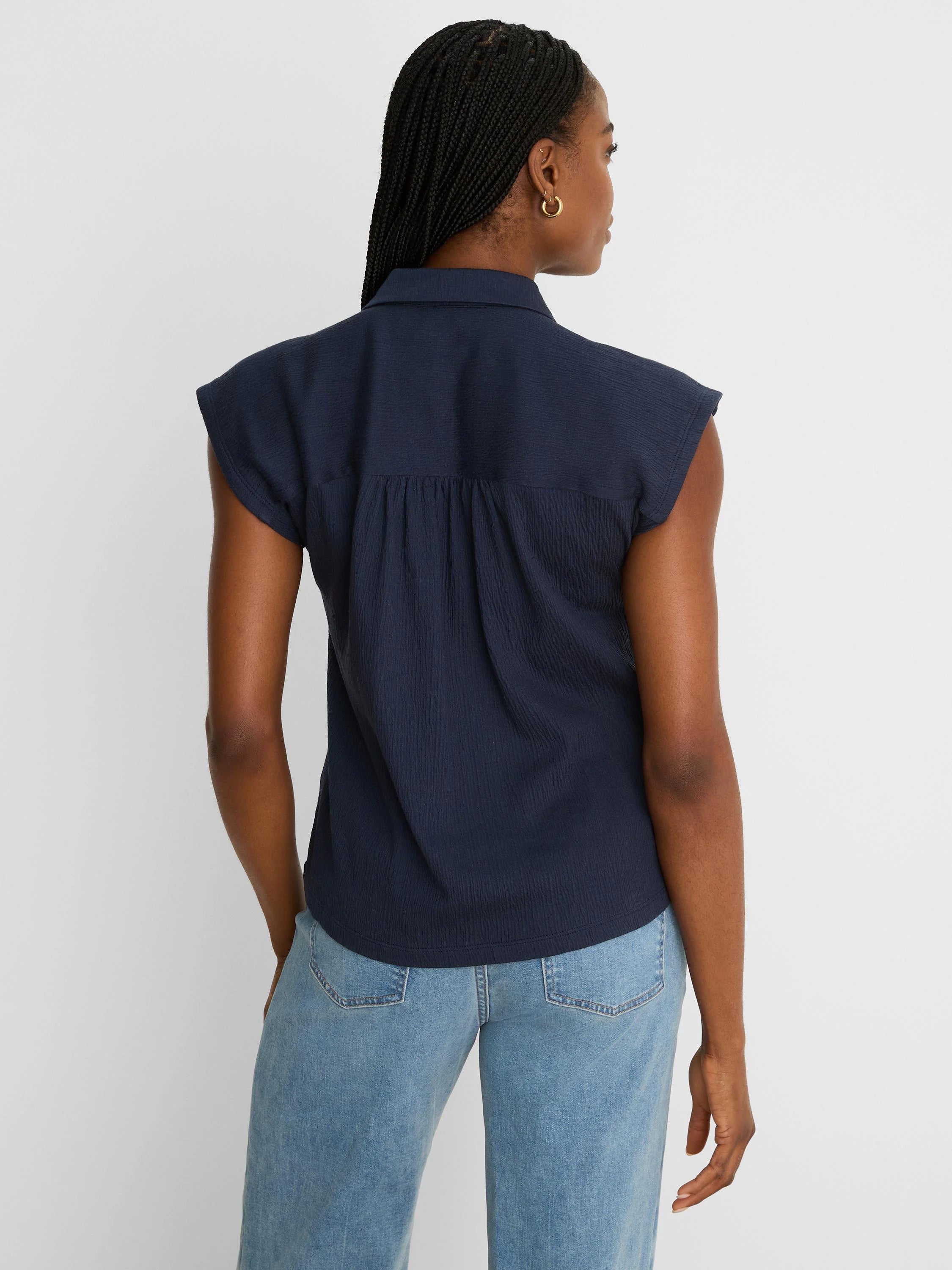 Navy crinkle top, seen from behind, features a collar, cap sleeves, and a gathered back yoke.