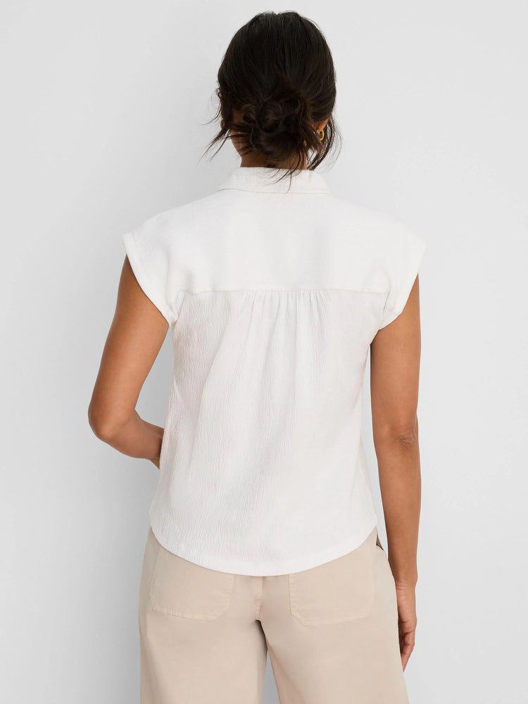 Off-white crinkle top with a collar, cap sleeves, and gathered back.