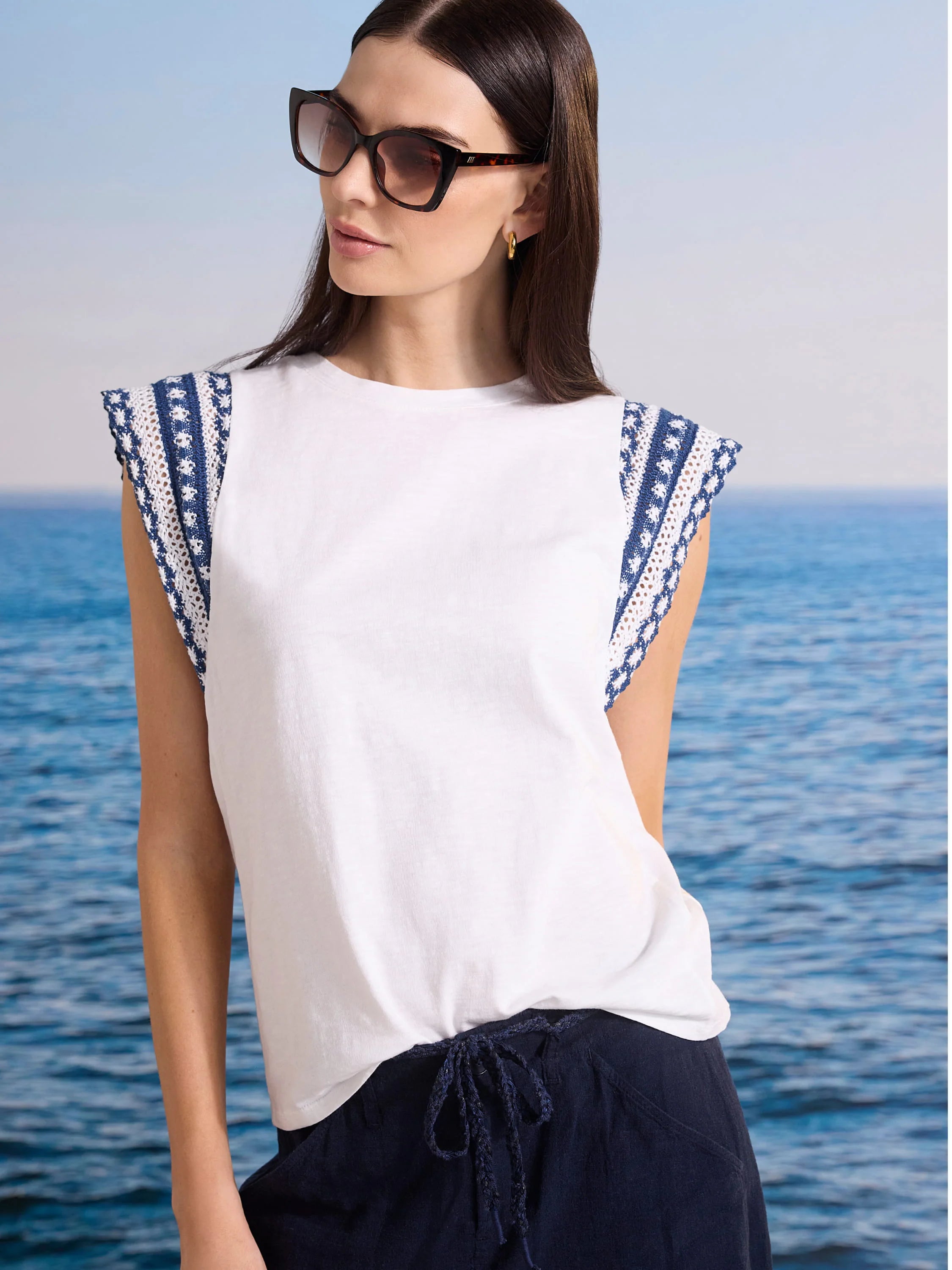 White cotton slub top with patterned navy and white knit trim cap sleeves.
