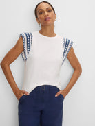 Off-white cotton slub top, crew neck, with navy & white patterned knit shoulder trim.