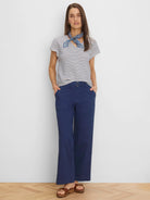 Cream short-sleeve top with horizontal navy diamond stripes.