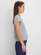 Cream top with navy diamond pattern forming stripes. Features short cap sleeves.