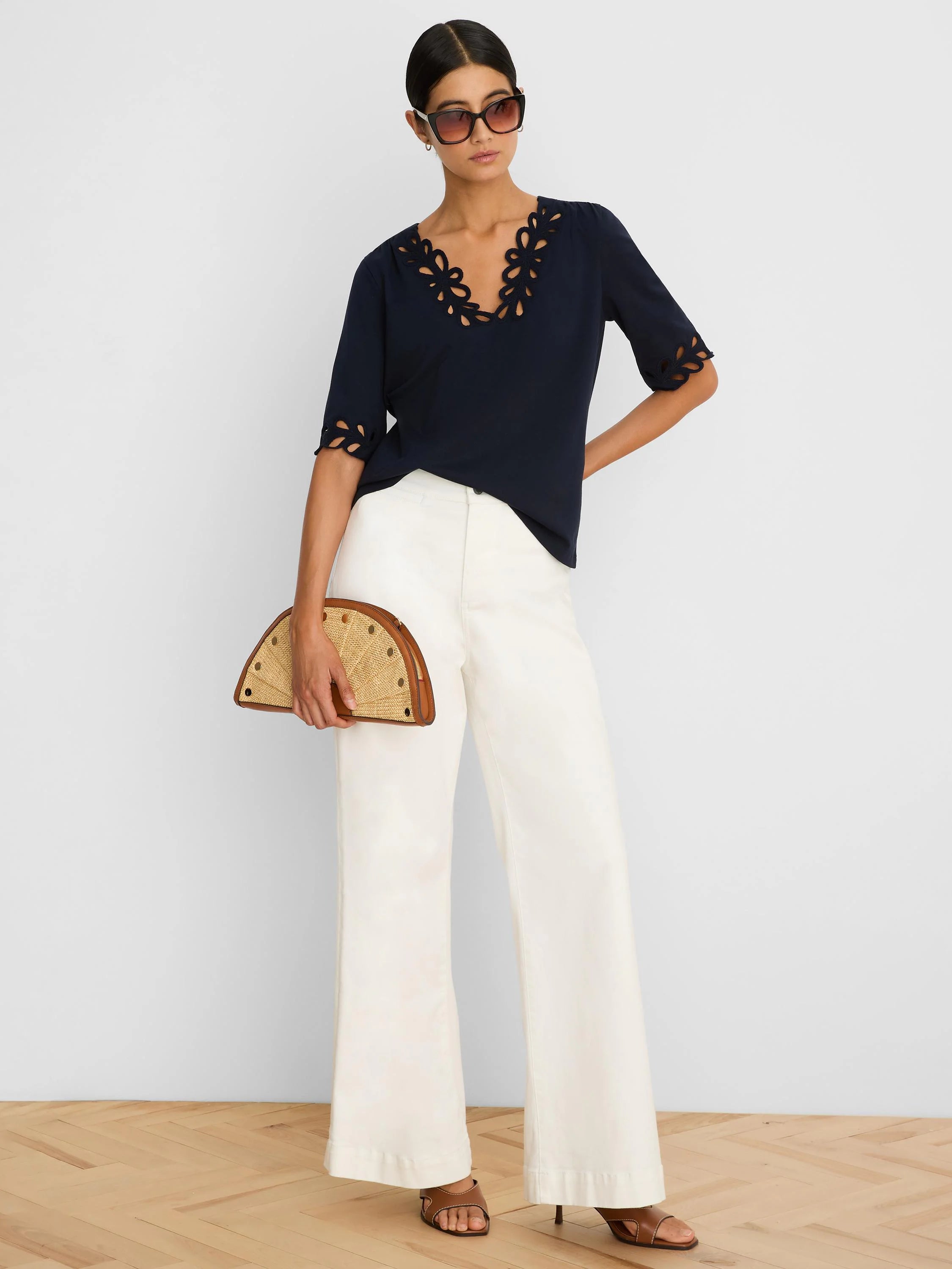 Navy V-neck top with scalloped cut-out details on the neckline and elbow-length sleeves.