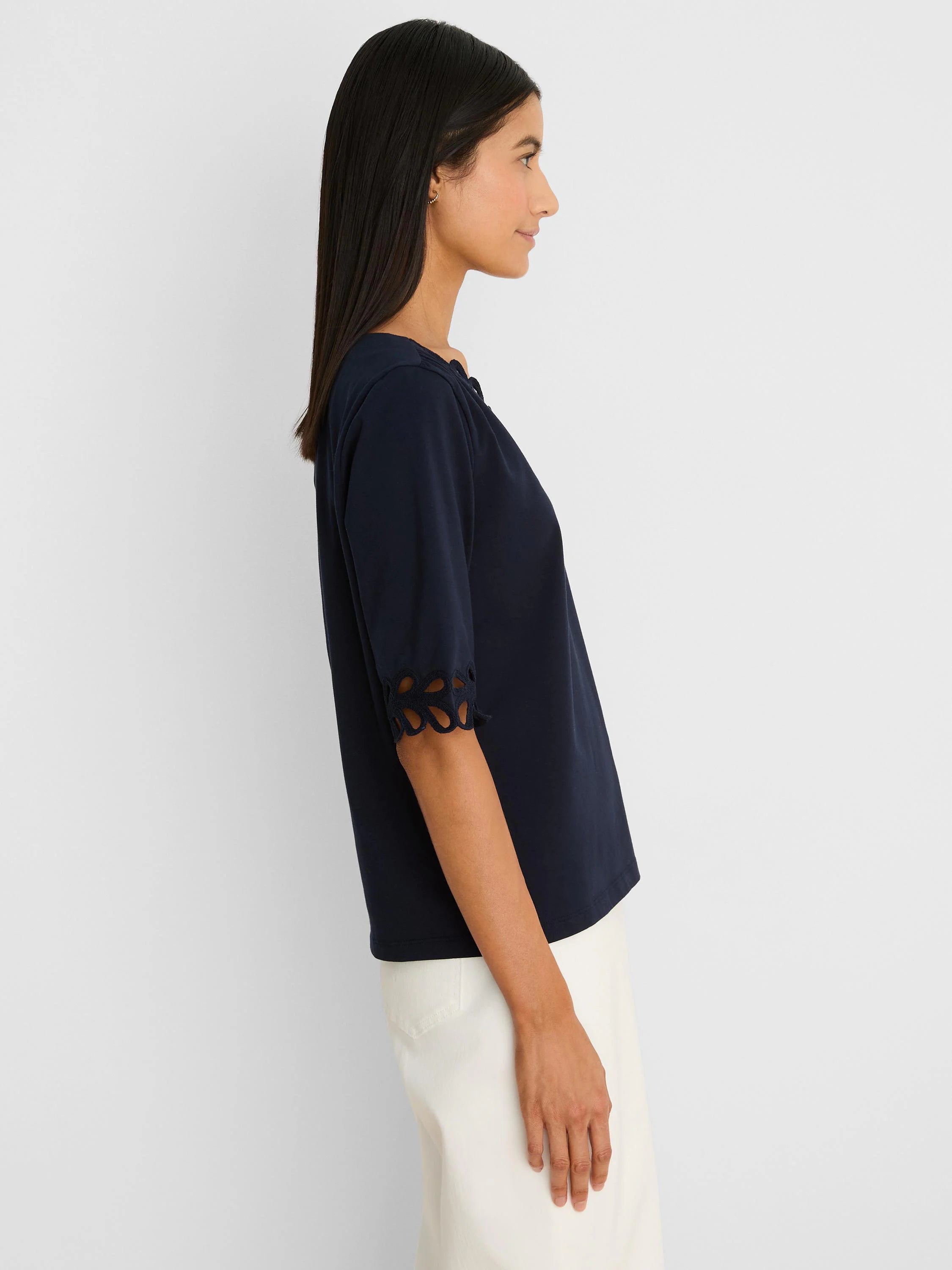 Navy blue top with gathered square neckline. 3/4 sleeves feature rococo-style cut-out edges.