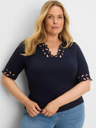 Navy blue V-neck top with cut-out decorative edges on the neckline and elbow-length sleeve cuffs.
