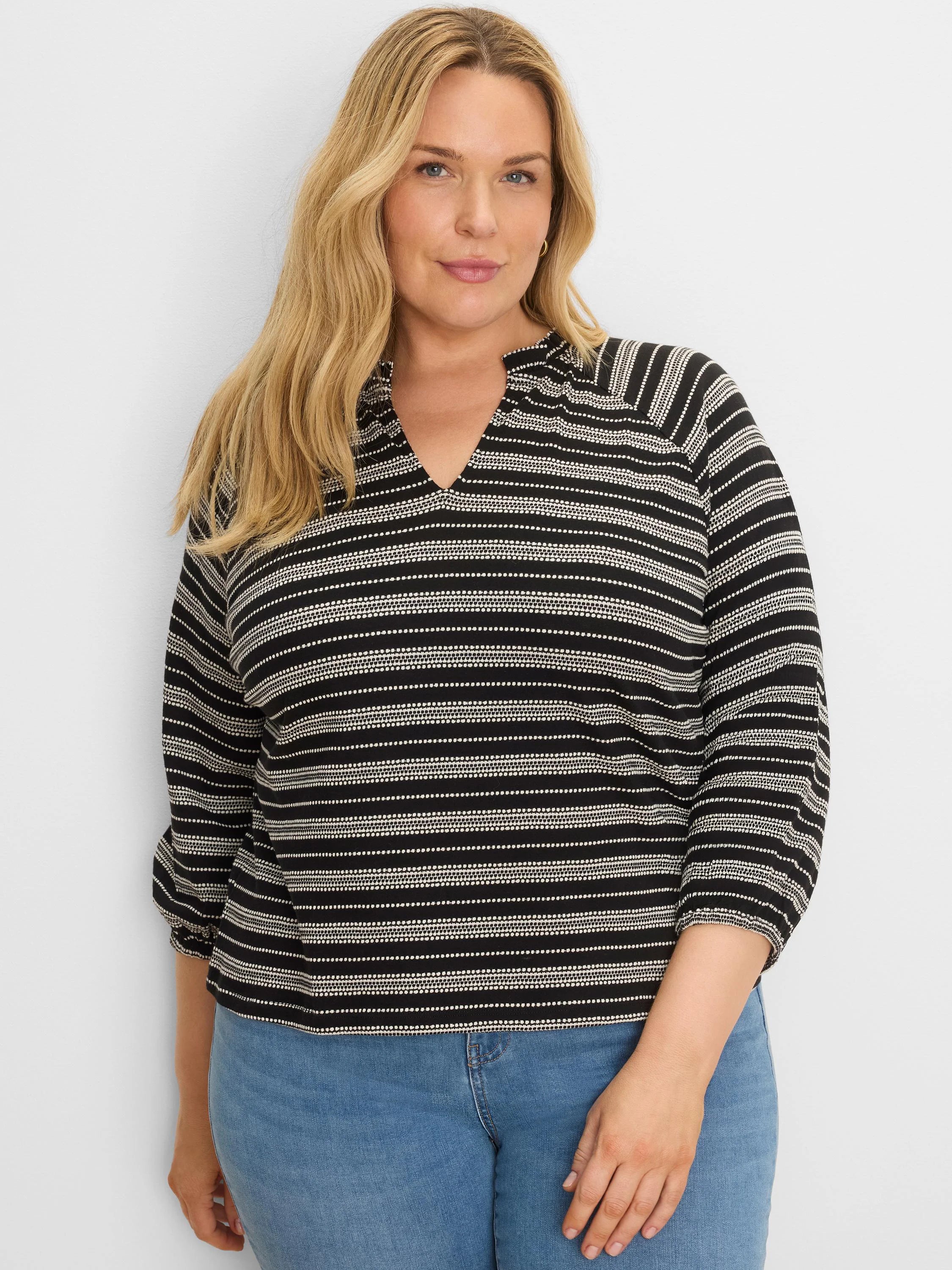 Black and white knit top with mixed horizontal stripes (solid & dotted), a split V-neck, and 3/4 sleeves.